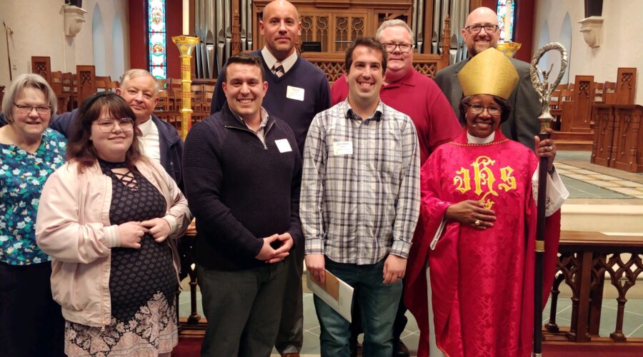 a photo of the newly confirmed and their sponsors with the Bishop