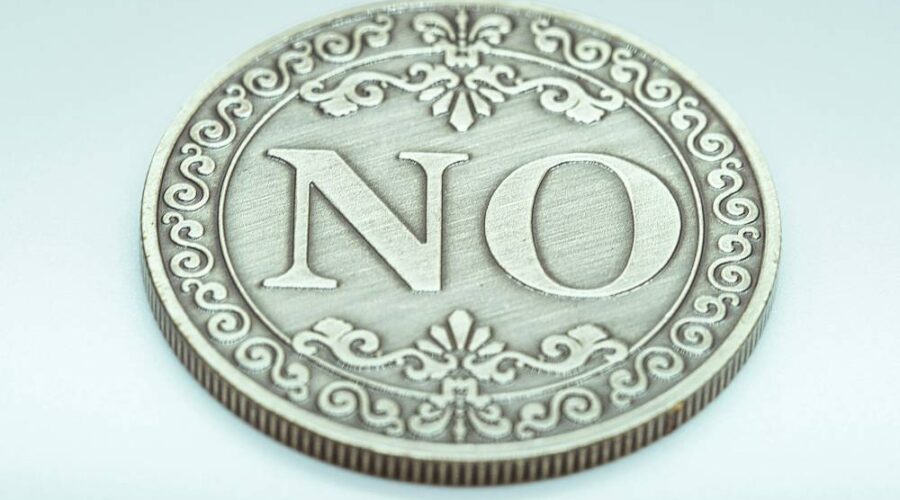 a decorative coin with the word "NO"