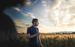 a man in a blue polo shirt in a field