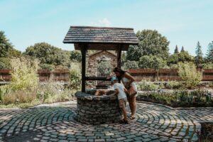 two people looking into a well