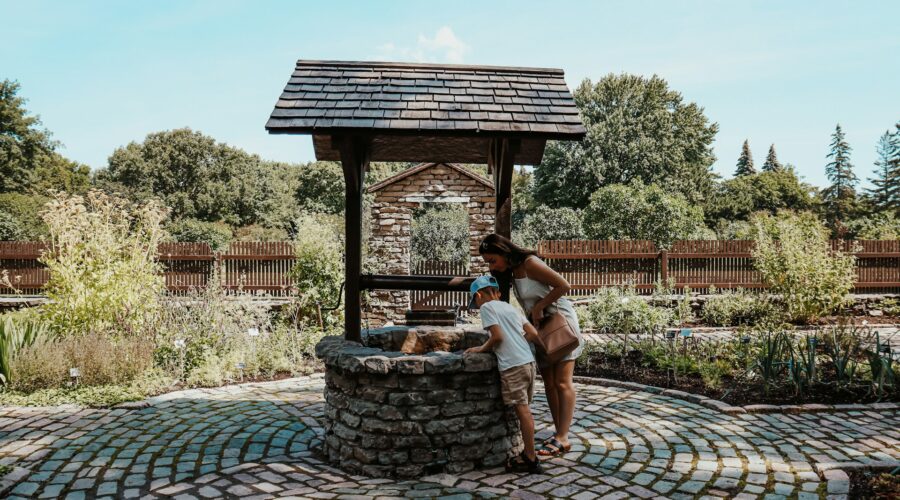 two people looking into a well