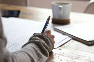 person writing in a notebook