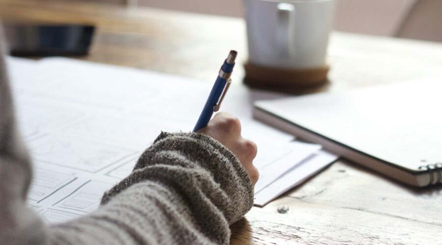 person writing in a notebook