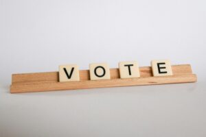 Scrabble tiles arranged to say "vote"