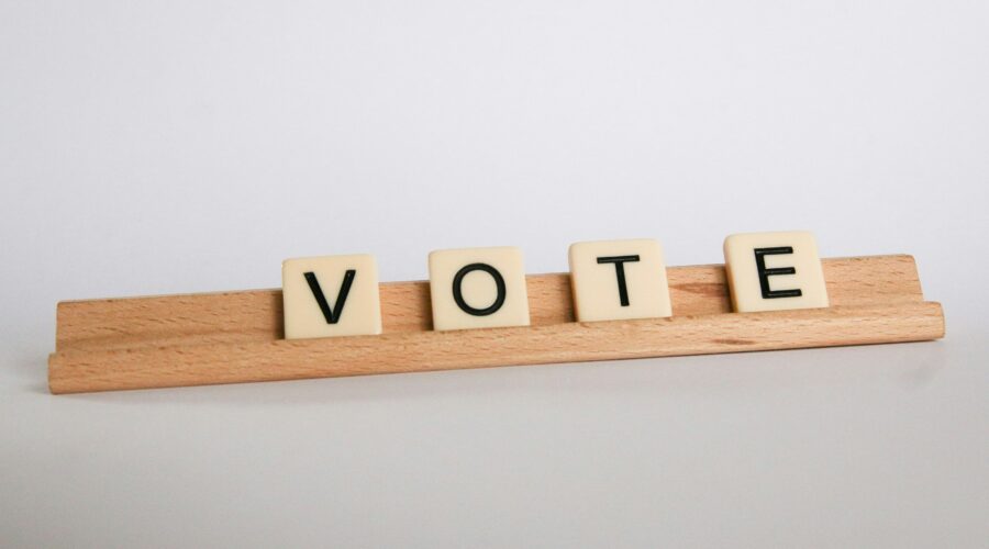 Scrabble tiles arranged to say "vote"
