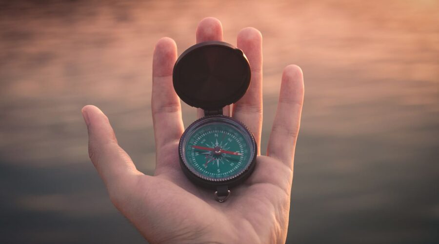 a photo of a hand holding a compass