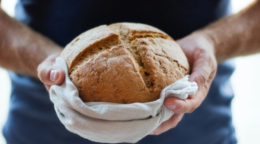 a photo of a person holding bread